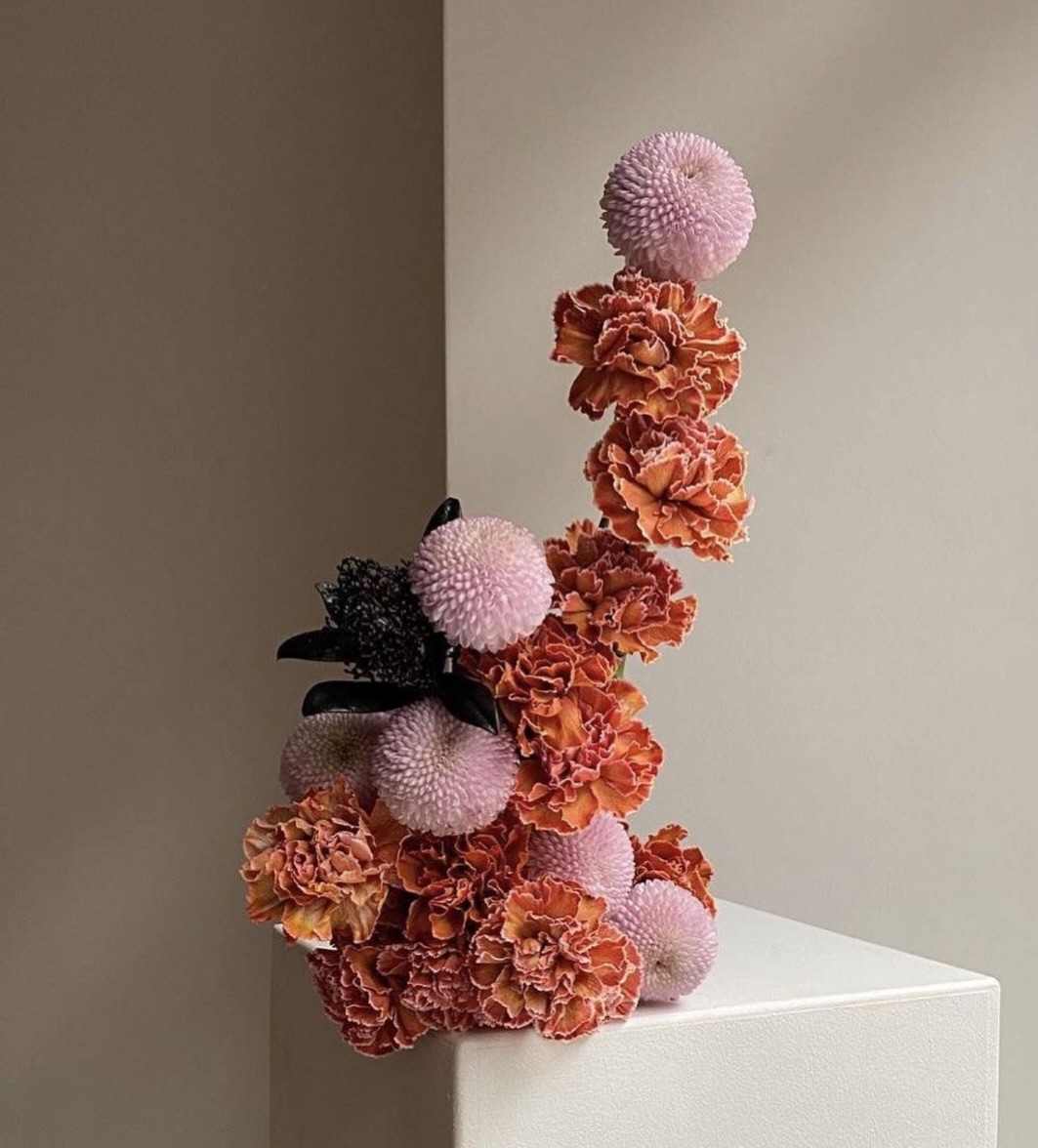 Orange carnation sculptural tower arrangement — Maison Bloom Bali