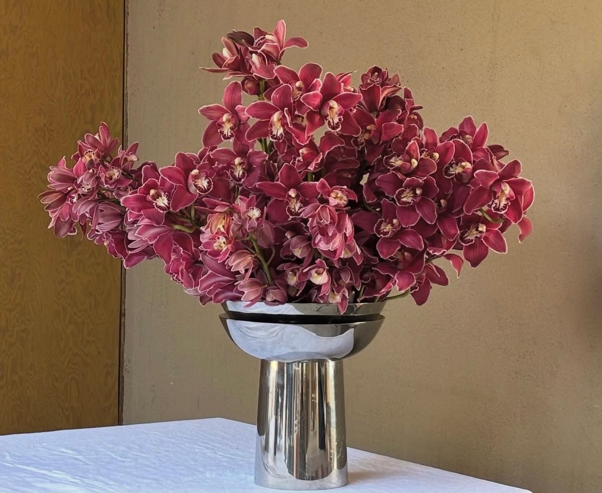 Pink orchids with mixed blooms in terracotta — Maison Bloom Bali